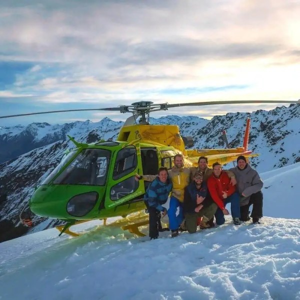 Group picture in front of helicopter